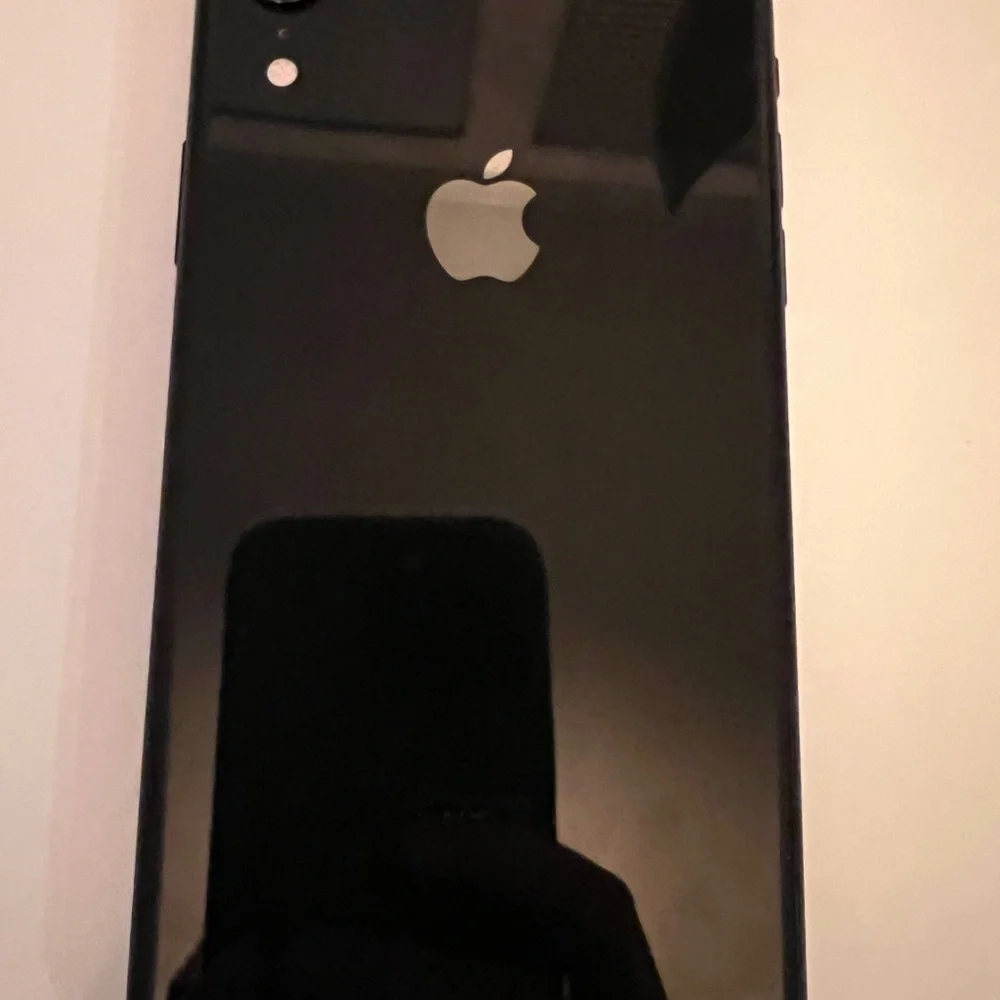 Apple Black XR - 128 GB, unlocked phone with two cases.